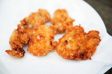 golden, crispy fried chicken pieces in bubbling oil, symbolizing indulgence and temptation