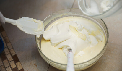 hands delicately layering ingredients to create a luscious tiramisu, showcasing the artistry of homemade desserts