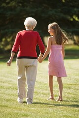 Naklejka premium Grandmother And Granddaughter Holding Hands