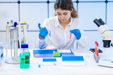 young woman in a university laboratory performing genetic analysis