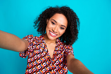 Photo of adorable cheerful lady wear print shirt recording video vlog empty space isolated blue...