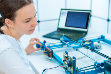 young female student studying industrial laser