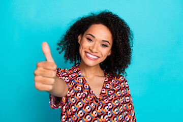Photo of charming girly lady wear print shirt showing you thumb up isolated blue color background