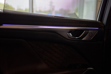 Automotive door with purple light, enhancing vehicle exterior design