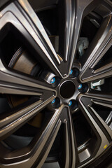 Detailed shot of a sleek black and silver alloy wheel on a motor vehicle