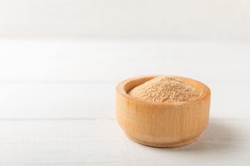 Cinnamon sugar on a texture background. Homemade cinnamon sugar in a bowl on background. Brown sugar. Spice mixture for drinks and baking. Place for text. Copy space.
