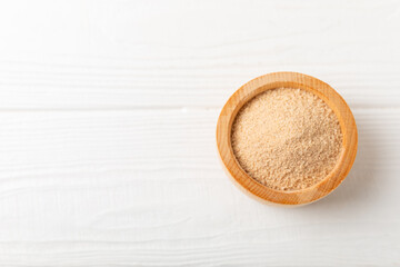 Cinnamon sugar on a texture background. Homemade cinnamon sugar in a bowl on background. Brown sugar. Spice mixture for drinks and baking. Place for text. Copy space.