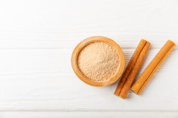 Cinnamon sugar on a texture background. Homemade cinnamon sugar in a bowl on background. Brown sugar. Spice mixture for drinks and baking. Place for text. Copy space.