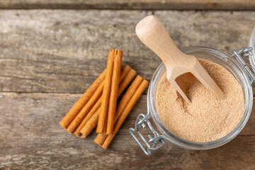Cinnamon sugar on a texture background. Homemade cinnamon sugar in a bowl on background. Brown sugar. Spice mixture for drinks and baking. Place for text. Copy space.