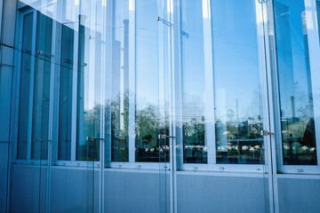 Serene Reflections: The Harmony of Glass Architecture and Urban Tranquility. This image illustrates...