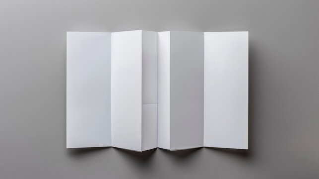 Blank white paper folded brochure on gray background.