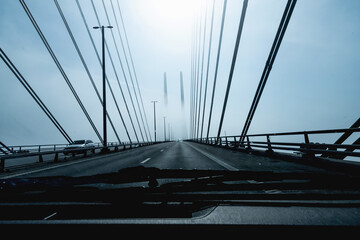 Obraz premium High-speed road bridge view from a fast-moving car. Road and railway blidge connecting Denmark and Sweden.