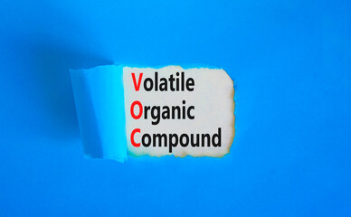 VOC volatile organic compound symbol. Concept words VOC volatile organic compound on beautiful white paper. Beautiful blue background. Business VOC volatile organic compound concept. Copy space.