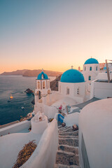 Fantastic Mediterranean Santorini island, Greece. Amazing romantic sunrise in Oia background, morning light. Amazing sunset view, white houses blue domes. Panoramic travel landscape. Love honeymoon 