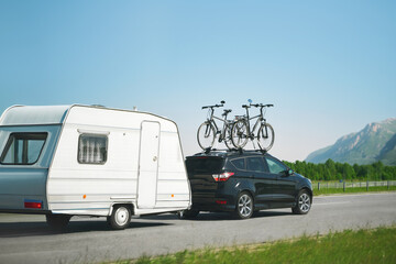 Family summer road trip with caravan and bicycles