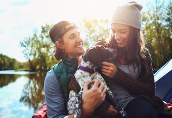 Couple, camping and lake in nature with dog for freedom, adventure travel with sustainability. Man,...