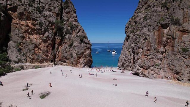 Group of People Stand on Sandy Beach in Sa Calobra, Palma De Mallorca