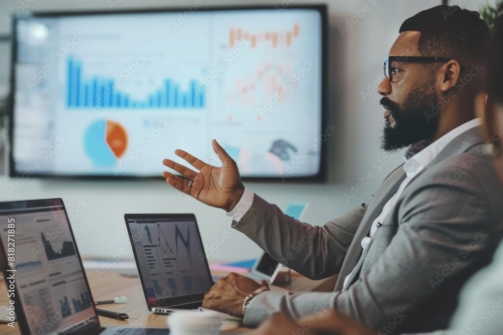 Aufkleber confident businessman gesturing towards a screen displaying data analysis in a corporate meeting set