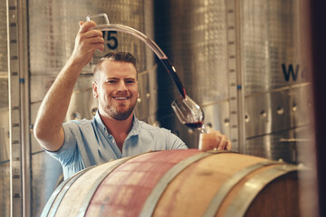 Man, happy and wine maker with pouring in glass as manager for tasting, process and production....