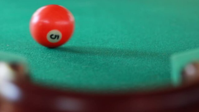 A bright composition with a game of billiards, when the balls have just fallen into the hole.
