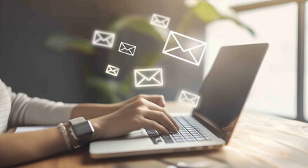 
A person typing on their laptop, with an email icon appearing in the message box of stamp ramping website and digital marketing 