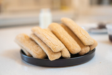 ladyfingers on a black plate for a tiramisu recipe