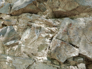 Fototapeta premium A close-up image of the weathered and textured surface of a natural stone material.