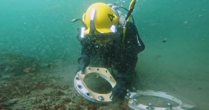 Commercial diver works on underwater pipeline