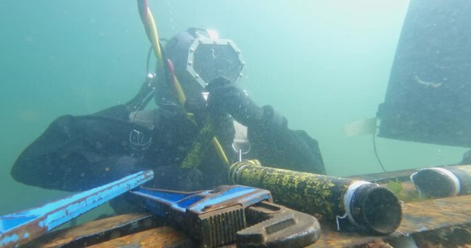 Commercial diver works on underwater pipeline