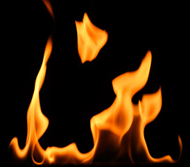 fire on a black background, burning and hot flames, close view