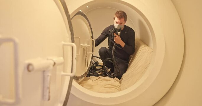 Military man in hyperbaric chamber using BIBS mask closeup