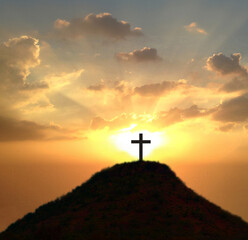 Cross against the sky . Dramatic nature background . Light from sky