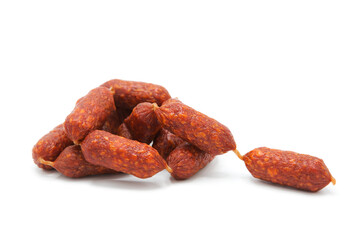 Pile of mini smoked dry-cured sausages isolated on a white background. Meat products and delicacies.