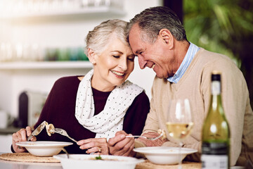 Senior couple, dinner and smile in home for anniversary, date or retirement with love in marriage....