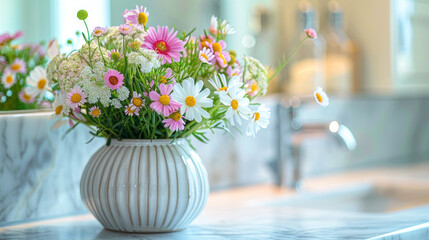 A vase filled with flowers placed on a kitchen counter