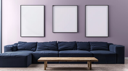 A serene living room with a soft lilac wall. Three blank frames in different sizes are grouped asymmetrically above a contemporary navy blue sofa. A low wooden table is placed in the foreground.