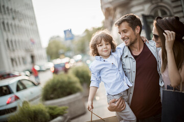 Family shopping trip with young child in city