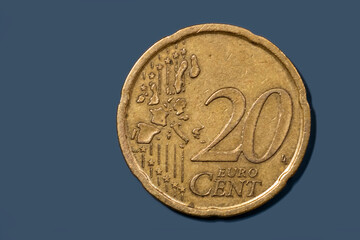 Close up view of 20 cent euro coin on blue background.