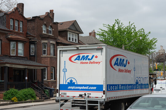 AMJ Home Delivery truck stopped in traffic on Spadina Road in Toronto, Canada
