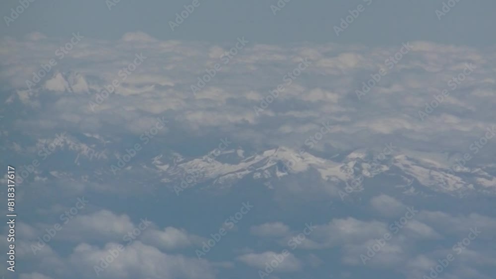 Aufkleber alps mountains visible between clouds and covered with snow - top view of airplane flight. topics: t