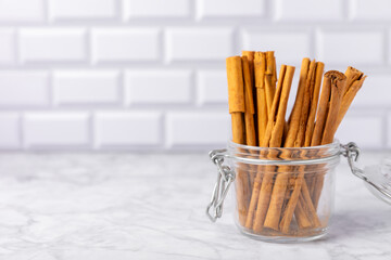 Ceylon cinnamon.Cinnamon sticks on a textured wooden background. Cinnamon roll and powder. Spicy spice for baking, desserts and drinks. Fragrant ground cinnamon. Close-up. Place for text. copy space