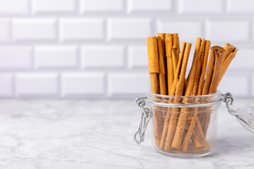 Ceylon cinnamon.Cinnamon sticks on a textured wooden background. Cinnamon roll and powder. Spicy...