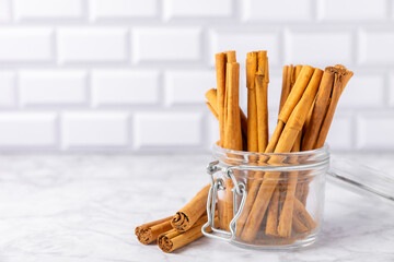Ceylon cinnamon.Cinnamon sticks on a textured wooden background. Cinnamon roll and powder. Spicy spice for baking, desserts and drinks. Fragrant ground cinnamon. Close-up. Place for text. copy space