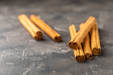 Ceylon cinnamon.Cinnamon sticks on a textured wooden background. Cinnamon roll and powder. Spicy spice for baking, desserts and drinks. Fragrant ground cinnamon. Close-up. Place for text. copy space