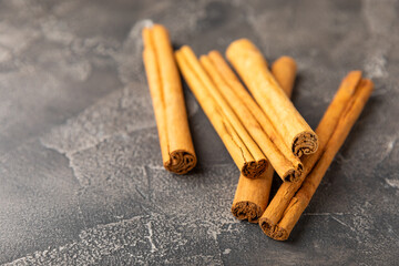 Ceylon cinnamon.Cinnamon sticks on a textured wooden background. Cinnamon roll and powder. Spicy spice for baking, desserts and drinks. Fragrant ground cinnamon. Close-up. Place for text. copy space