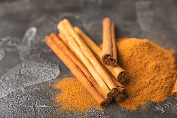 Ceylon cinnamon.Cinnamon sticks on a textured wooden background. Cinnamon roll and powder. Spicy spice for baking, desserts and drinks. Fragrant ground cinnamon. Close-up. Place for text. copy space