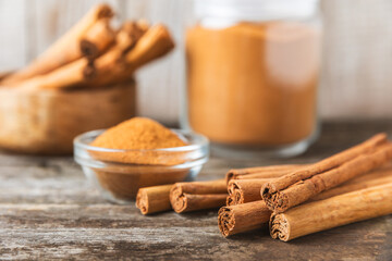 Ceylon cinnamon.Cinnamon sticks on a textured wooden background. Cinnamon roll and powder. Spicy spice for baking, desserts and drinks. Fragrant ground cinnamon. Close-up. Place for text. copy space
