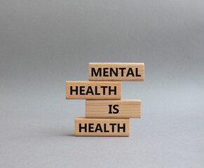 Mental Health symbol. Wooden blocks with words Mental Health is Health. Beautiful yellow...
