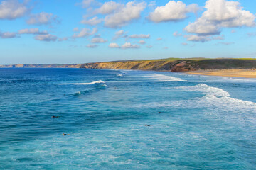 Atlantic ocean coastline and beach popular among surfers and tourists in Praia da Bordeira, Algarve, Portugal