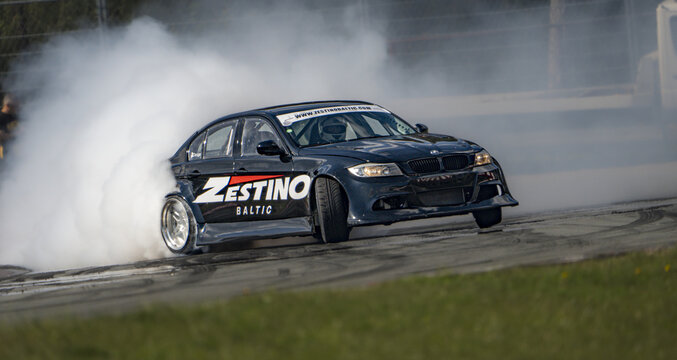 Riga 28-04-2024 Drift  A car emitting smoke from its tires races with Estimo inscribed on its front